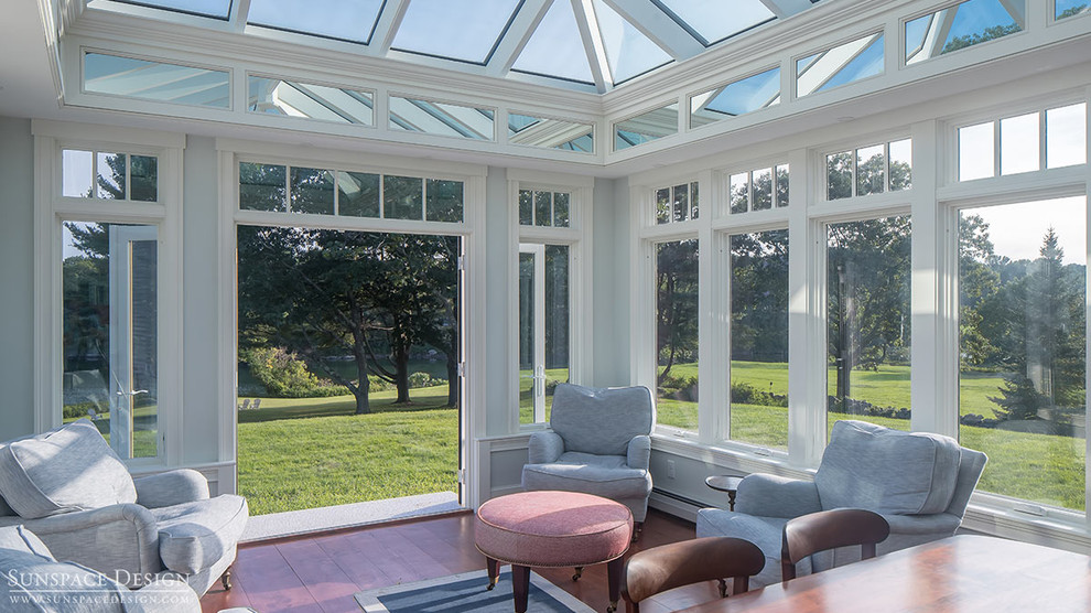 This is an example of a large traditional conservatory in Other with painted wood flooring and a glass ceiling.
