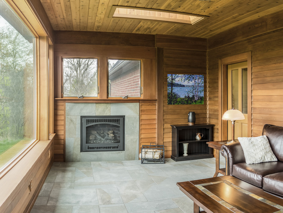 Inspiration for a craftsman ceramic tile sunroom remodel in Detroit with a standard fireplace, a tile fireplace and a skylight