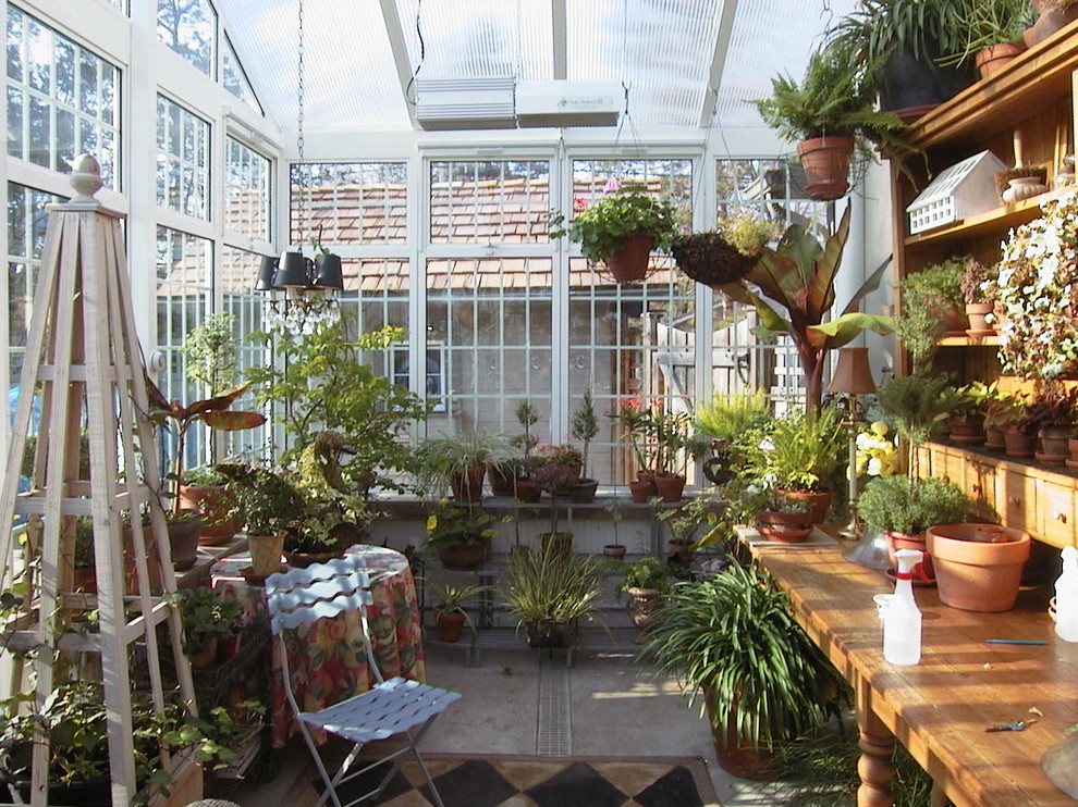Large classic conservatory in Minneapolis with concrete flooring and a skylight.