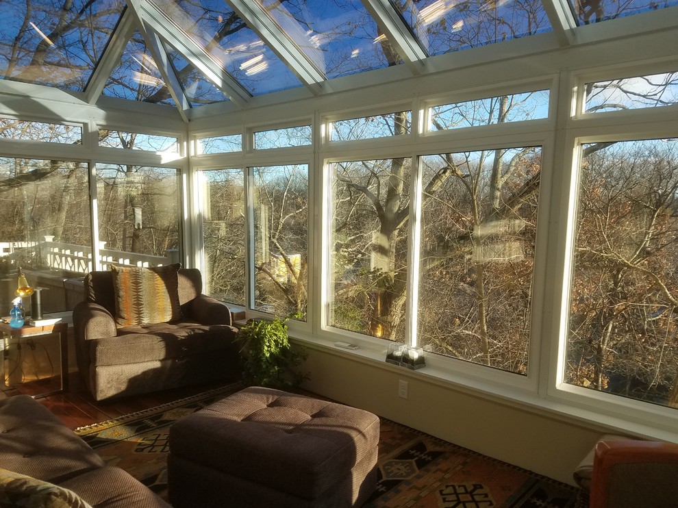 Design ideas for a medium sized classic conservatory in Boston with medium hardwood flooring and a glass ceiling.