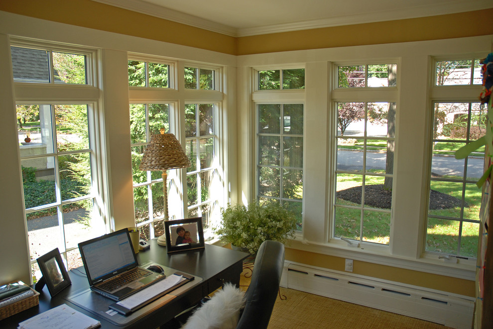 This is an example of a small classic conservatory in New York with no fireplace, a standard ceiling and carpet.