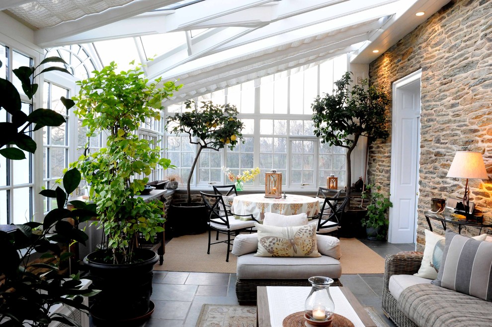 Immagine di una grande veranda classica con pavimento in ardesia e soffitto in vetro