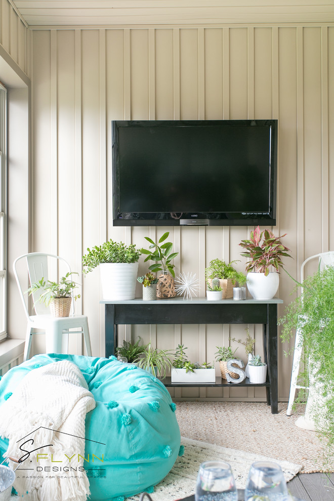 This is an example of a small coastal conservatory in Cleveland with laminate floors.