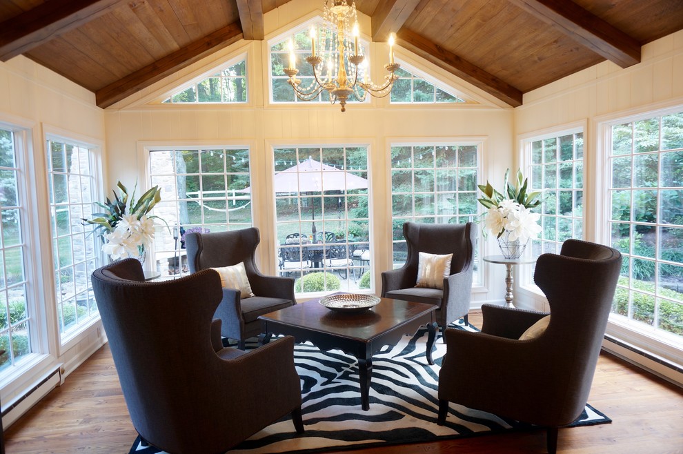 Photo of a large traditional conservatory in Cleveland with medium hardwood flooring, a standard ceiling and brown floors.