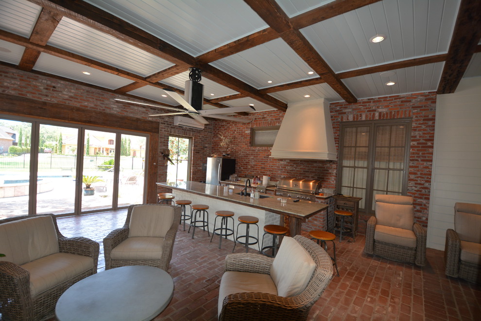 Photo of a large urban conservatory in New Orleans with brick flooring and a standard ceiling.