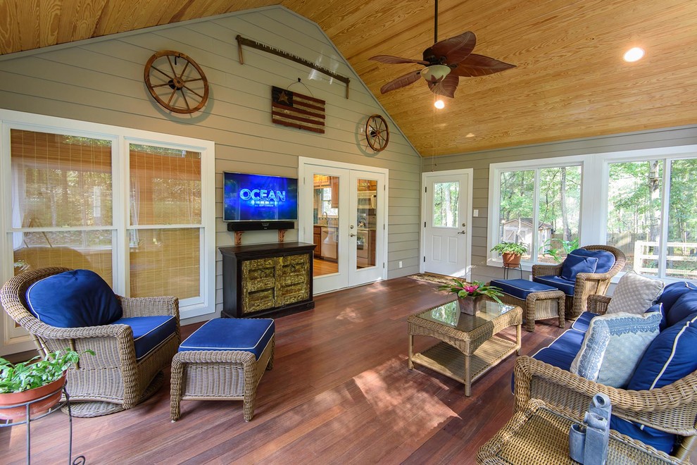 This is an example of a large country conservatory in Atlanta with medium hardwood flooring, no fireplace, a standard ceiling and brown floors.