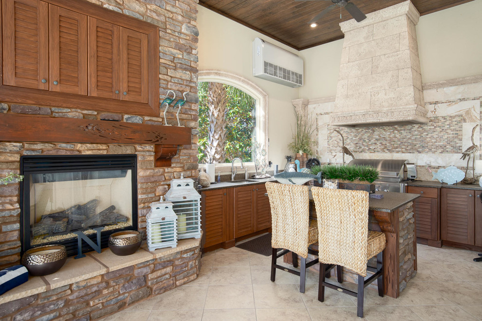 Mediterranean conservatory in Miami with a standard fireplace.