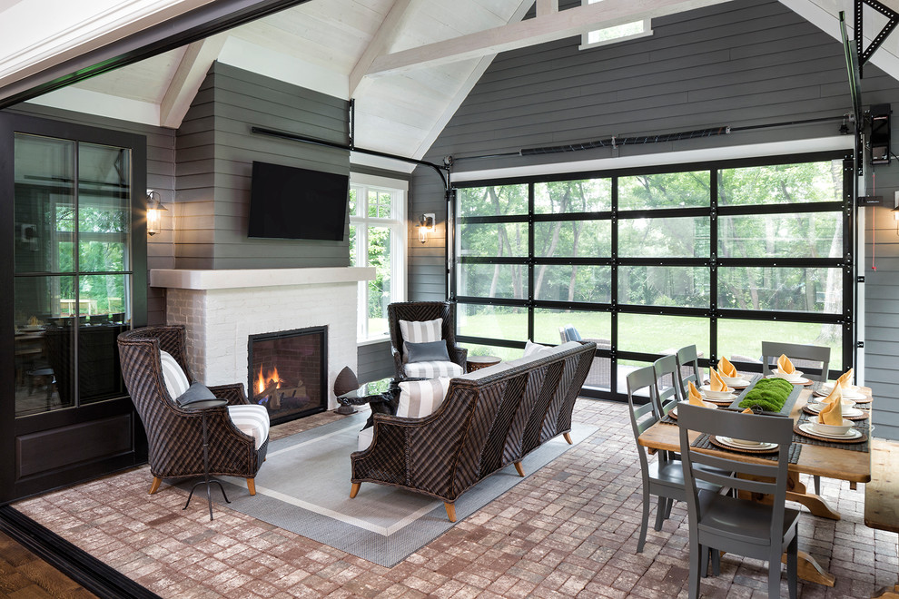 This is an example of a medium sized classic conservatory in Minneapolis with brick flooring, a standard fireplace, a brick fireplace surround, a standard ceiling and red floors.