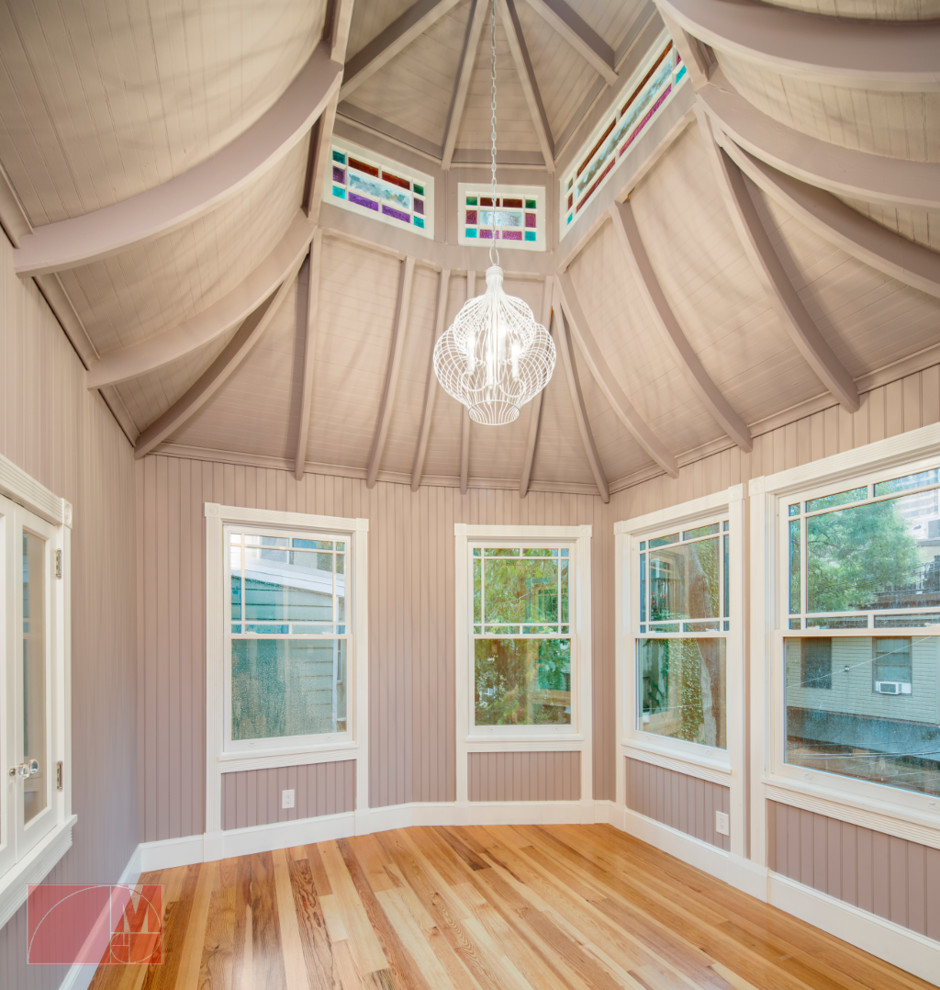 Inspiration for a large transitional light wood floor sunroom remodel in Philadelphia with a standard fireplace, a stone fireplace and a glass ceiling
