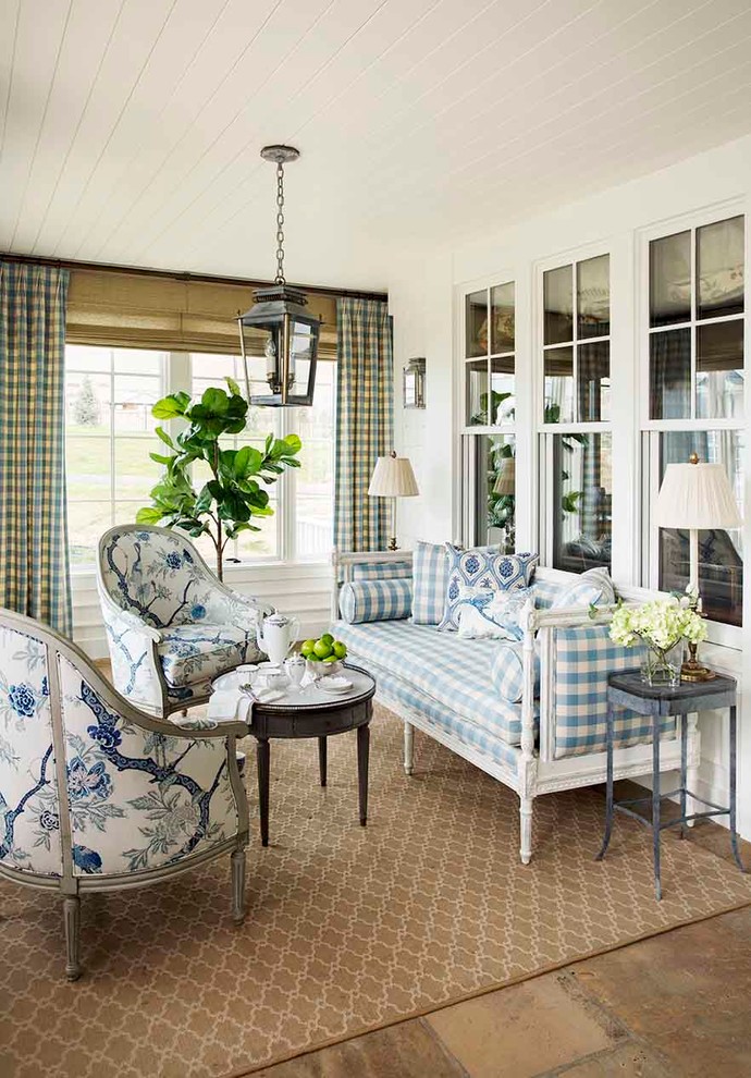 This is an example of a large classic conservatory in Los Angeles with limestone flooring, a standard ceiling and beige floors.