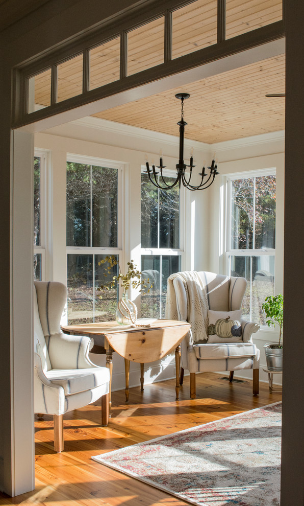 Mid-sized cottage medium tone wood floor and brown floor sunroom photo in Other with a standard ceiling