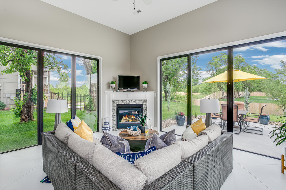 Inspiration for a mid-sized coastal concrete floor and white floor sunroom remodel in Wichita with a corner fireplace, a tile fireplace and a standard ceiling