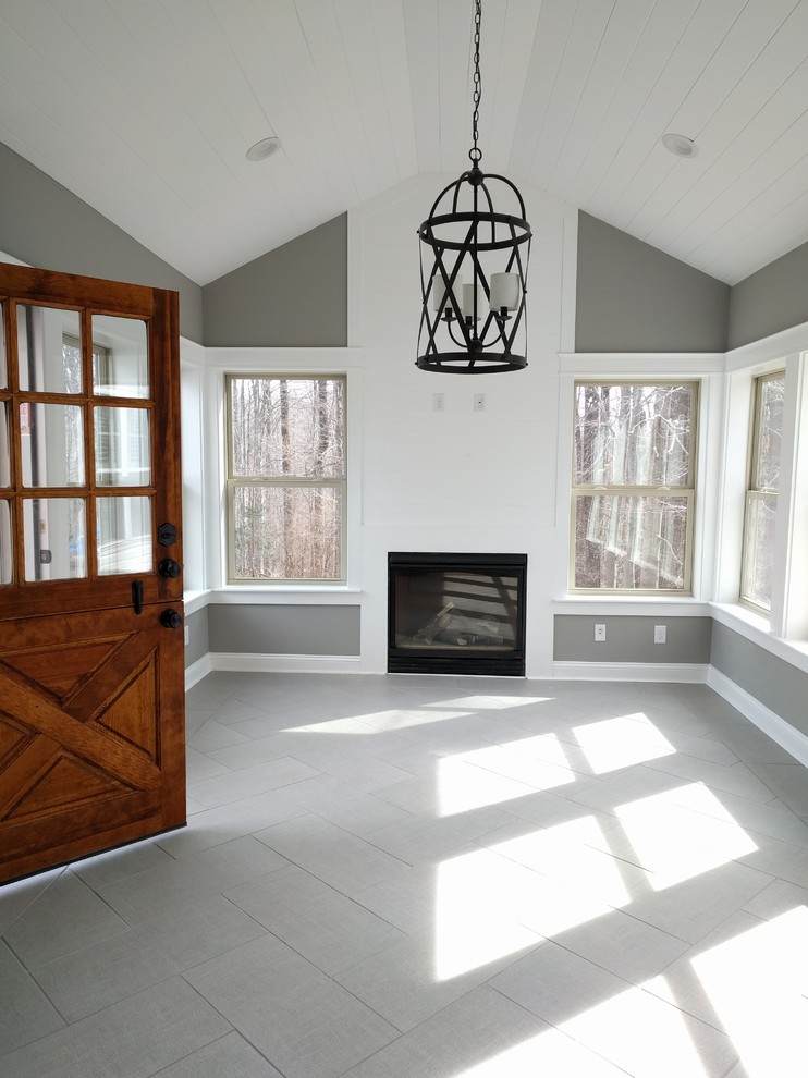 Example of a mid-sized transitional porcelain tile sunroom design in DC Metro with a standard fireplace, a wood fireplace surround and a standard ceiling