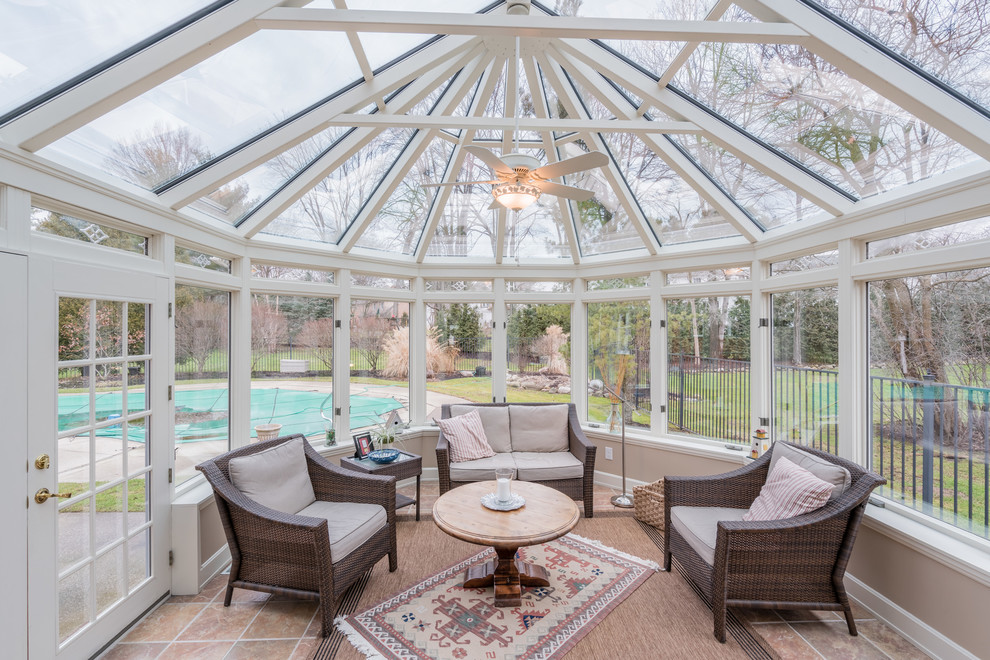 Inspiration for a traditional conservatory in Cleveland with a glass ceiling and brown floors.