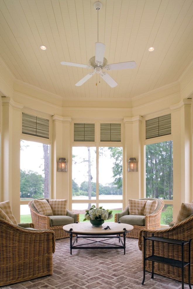 This is an example of a classic conservatory in Atlanta with brick flooring and a standard ceiling.