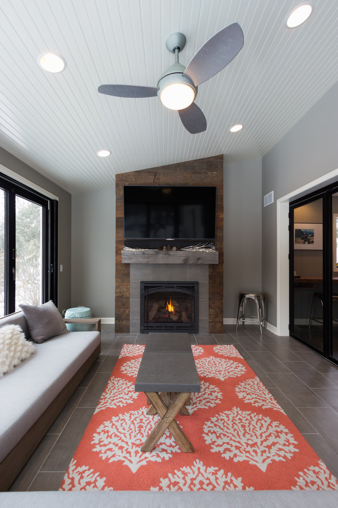 Example of a large classic porcelain tile and gray floor sunroom design in Chicago with a standard ceiling, a standard fireplace and a tile fireplace