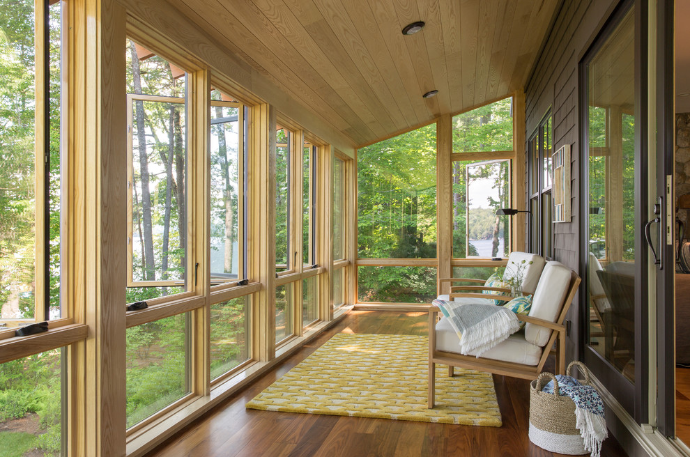 Mid-sized mountain style medium tone wood floor and brown floor sunroom photo in Portland Maine with a standard ceiling