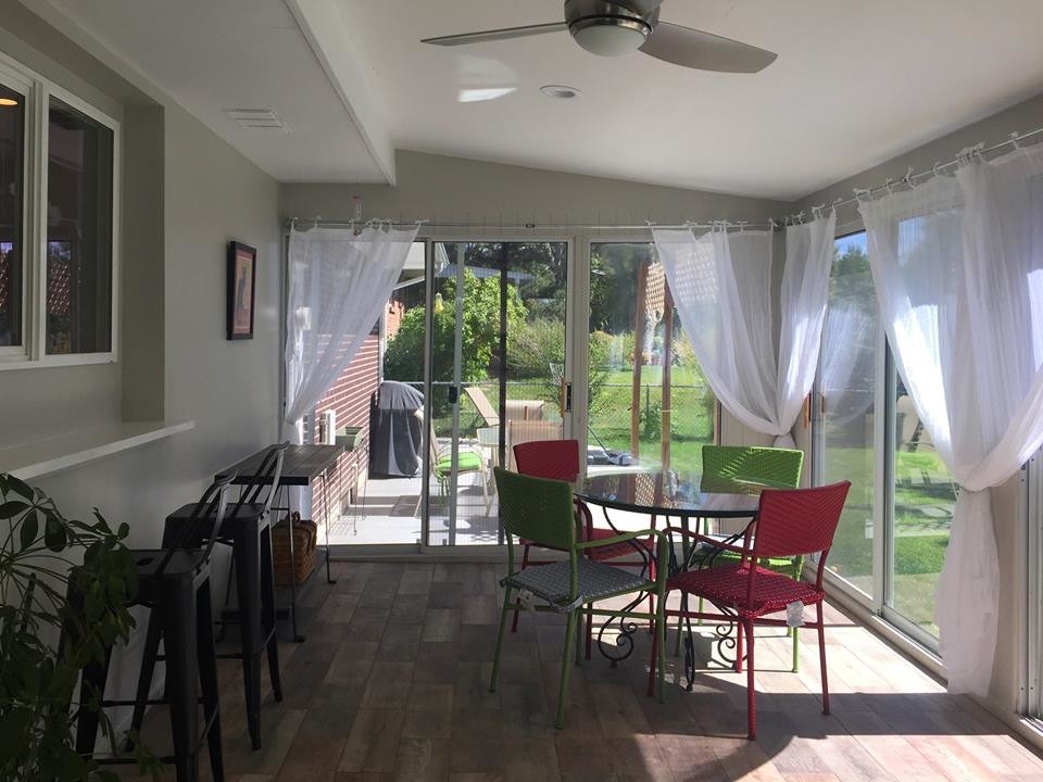 Example of a large transitional porcelain tile sunroom design in Denver with a standard ceiling