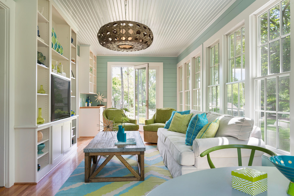 This is an example of a beach style conservatory in Providence with medium hardwood flooring, no fireplace, a standard ceiling and beige floors.