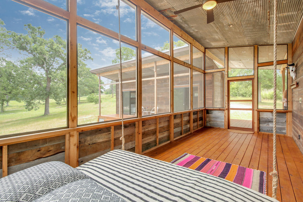 Sunroom - farmhouse medium tone wood floor and brown floor sunroom idea in Austin with no fireplace and a standard ceiling