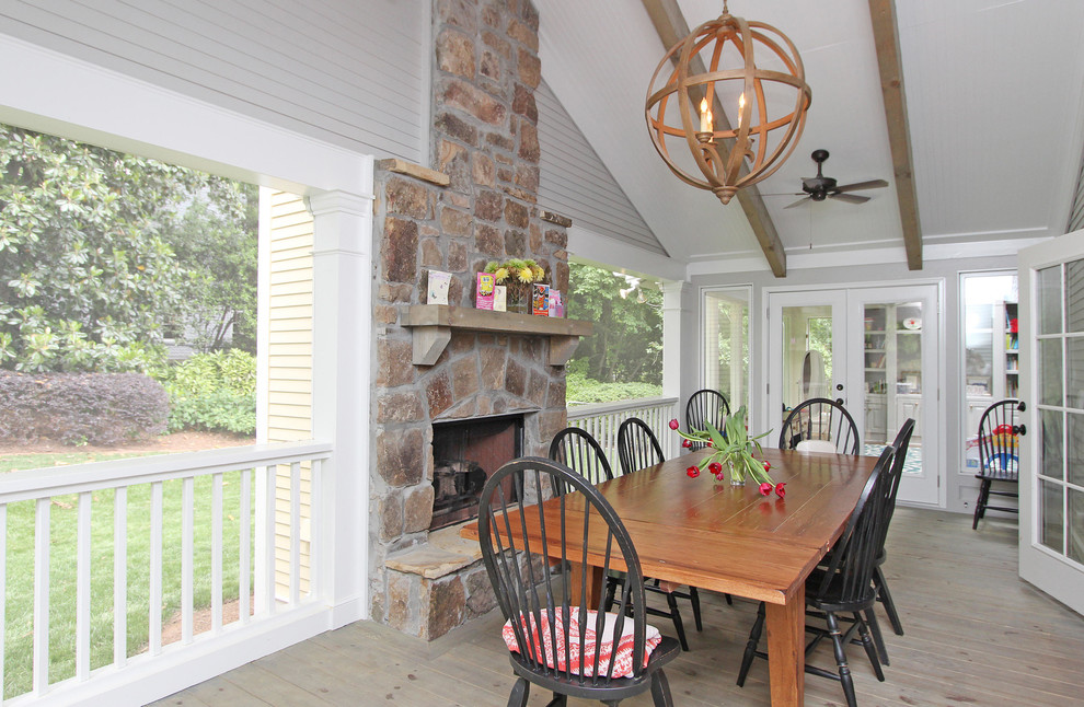 Inspiration for a large timeless light wood floor and gray floor sunroom remodel in Atlanta with a standard fireplace, a stone fireplace and a standard ceiling