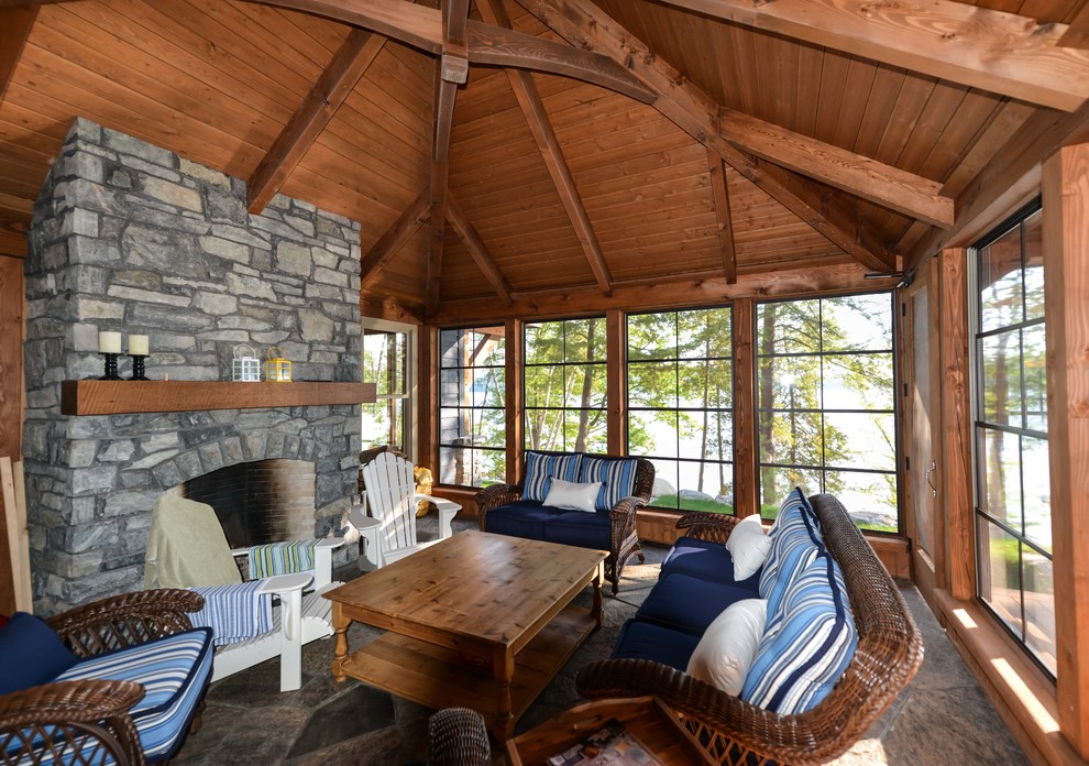 Inspiration for a mid-sized rustic slate floor sunroom remodel in Toronto with a stone fireplace, a standard ceiling and a standard fireplace