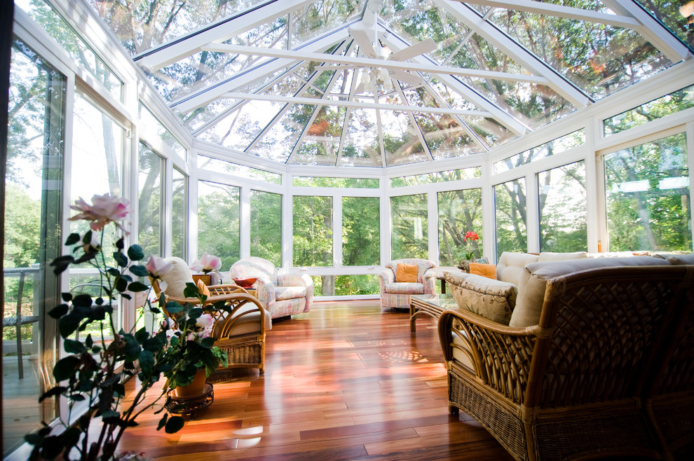 Photo of a traditional conservatory in Grand Rapids with dark hardwood flooring, no fireplace and a skylight.