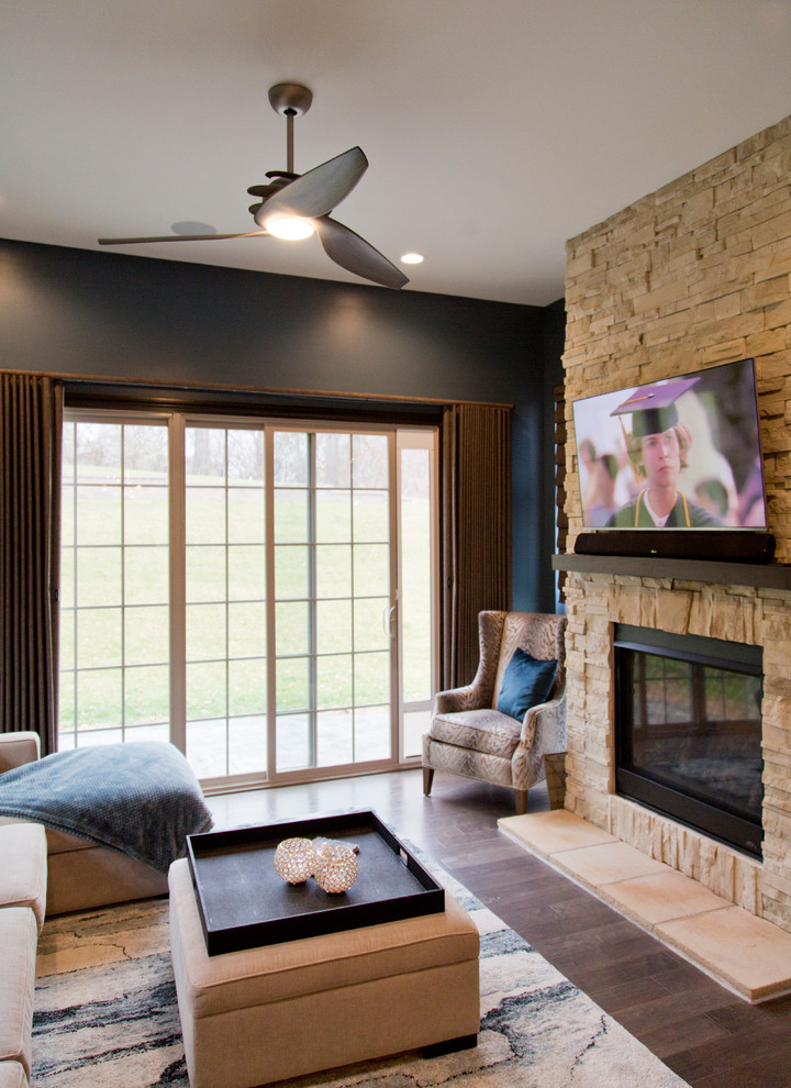 Inspiration for a mid-sized contemporary dark wood floor and brown floor sunroom remodel in St Louis with a standard fireplace, a stone fireplace and a standard ceiling