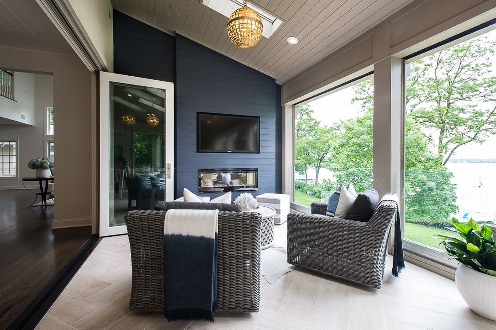 Inspiration for an expansive nautical conservatory in Milwaukee with porcelain flooring, a ribbon fireplace, a wooden fireplace surround, a skylight and beige floors.