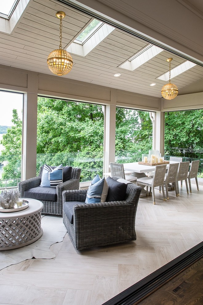 Photo of an expansive nautical conservatory in Milwaukee with porcelain flooring, a skylight, beige floors, a ribbon fireplace and a wooden fireplace surround.
