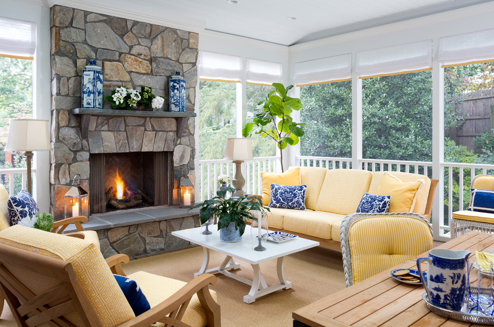 This is an example of a medium sized beach style conservatory in DC Metro with a standard fireplace, a stone fireplace surround and a standard ceiling.