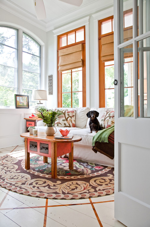 Pic of a small dog on a white slip-covered couch.