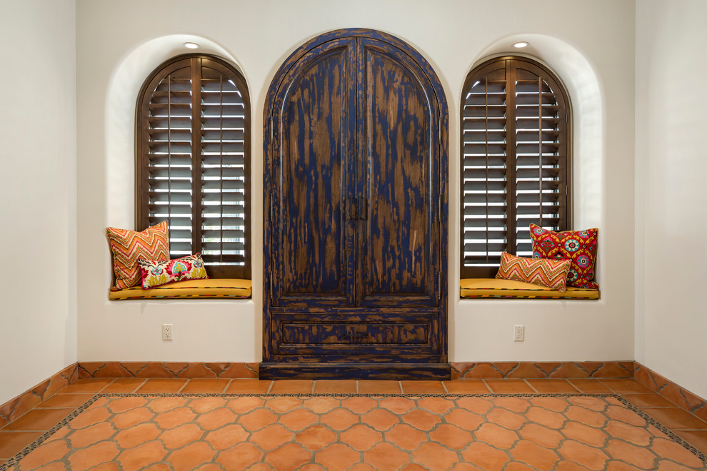 This is an example of a large mediterranean conservatory in Phoenix with terracotta flooring and orange floors.