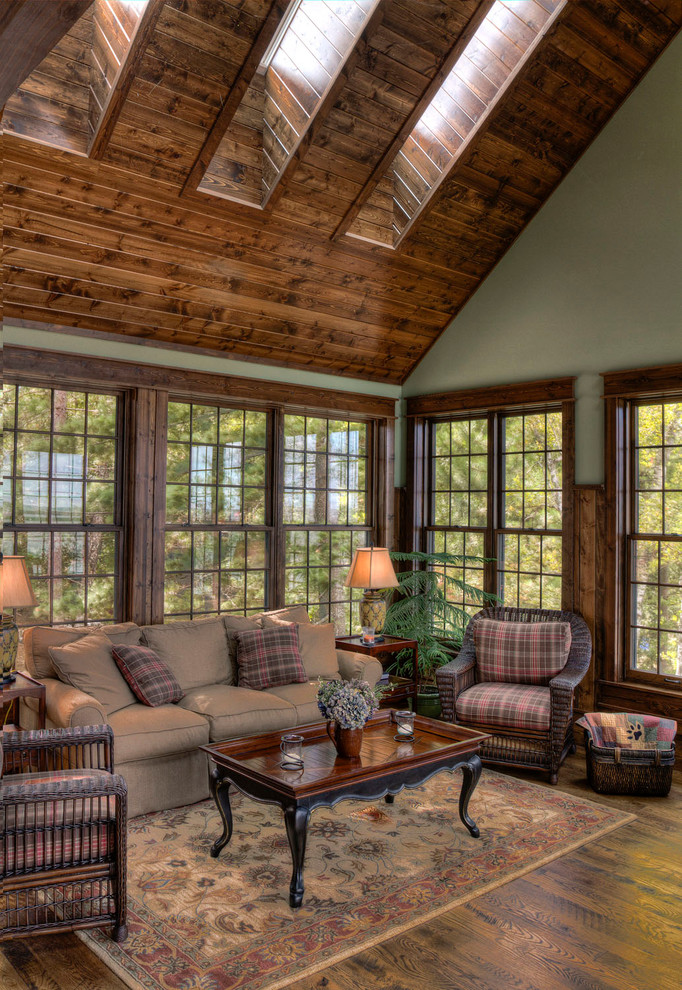 Rustic conservatory in Minneapolis with dark hardwood flooring, a skylight and brown floors.