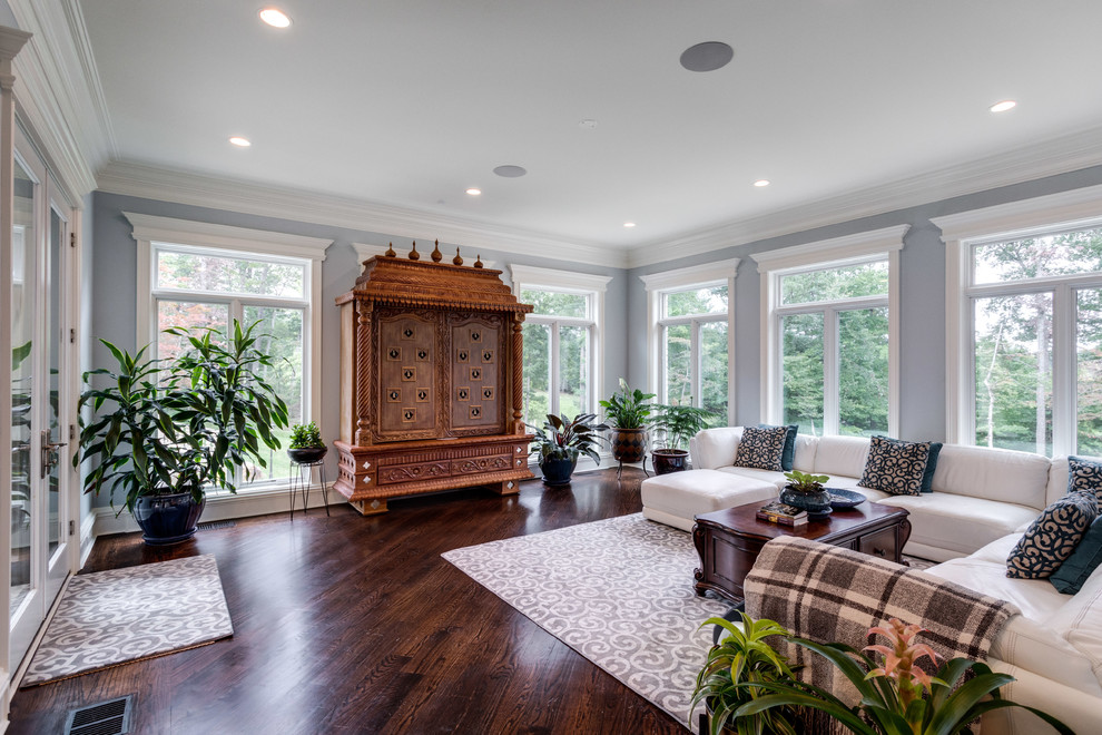 Photo of a traditional conservatory in DC Metro with dark hardwood flooring and brown floors.