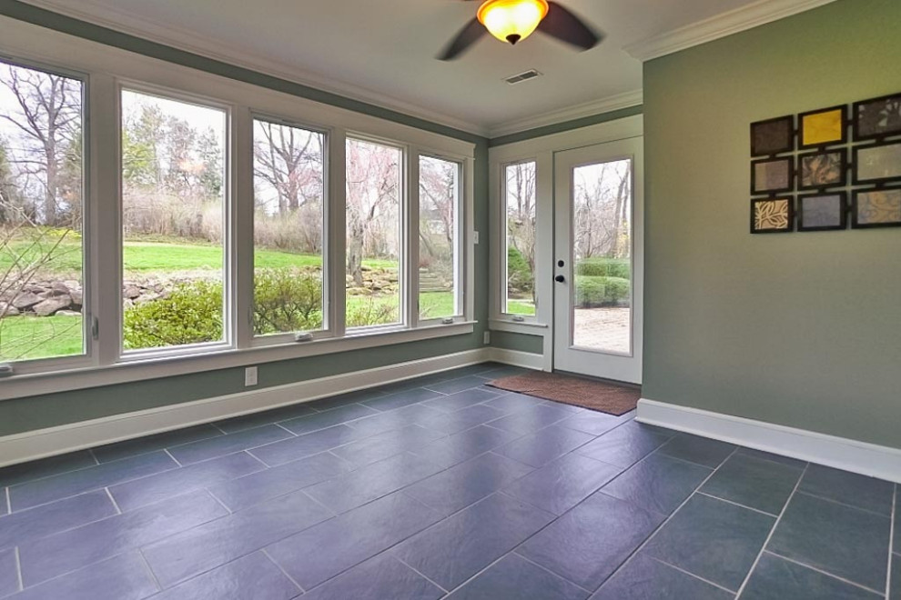 Retro conservatory in Cleveland with ceramic flooring and black floors.