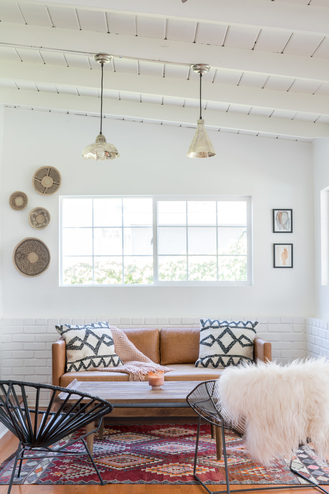Example of a large 1960s medium tone wood floor and brown floor sunroom design in Other