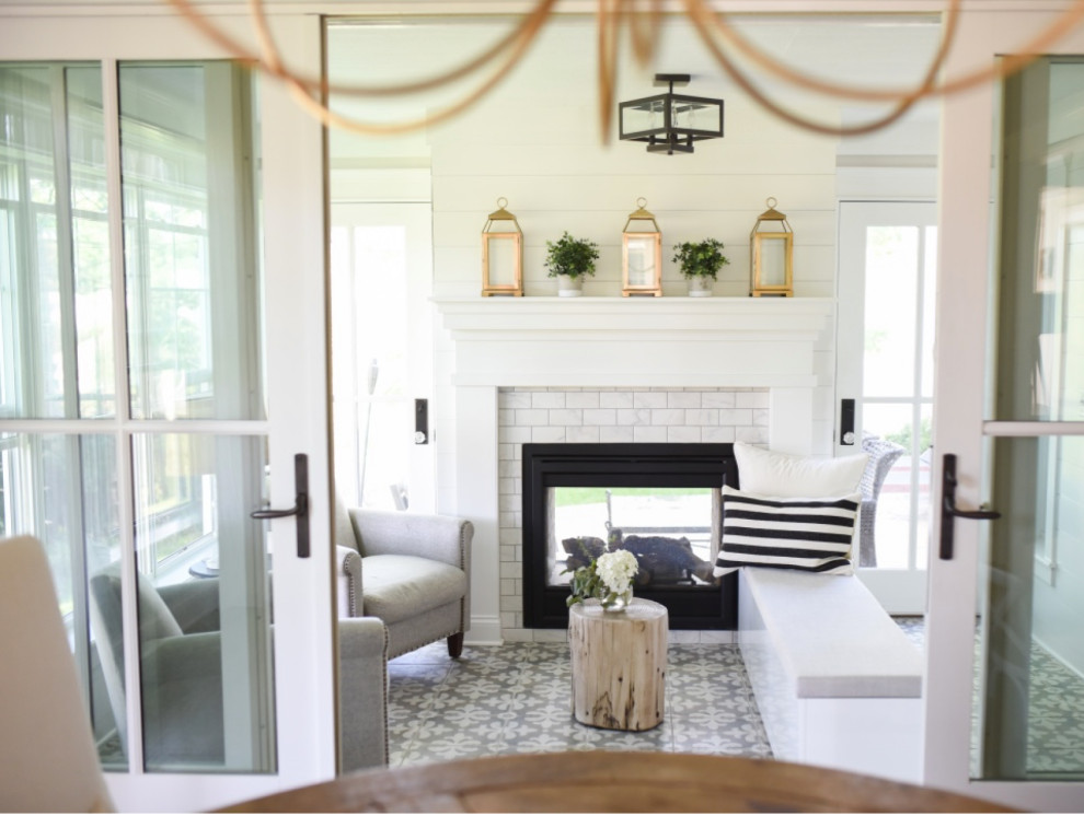 Inspiration for a classic conservatory in Milwaukee with porcelain flooring, a two-sided fireplace, a tiled fireplace surround and grey floors.