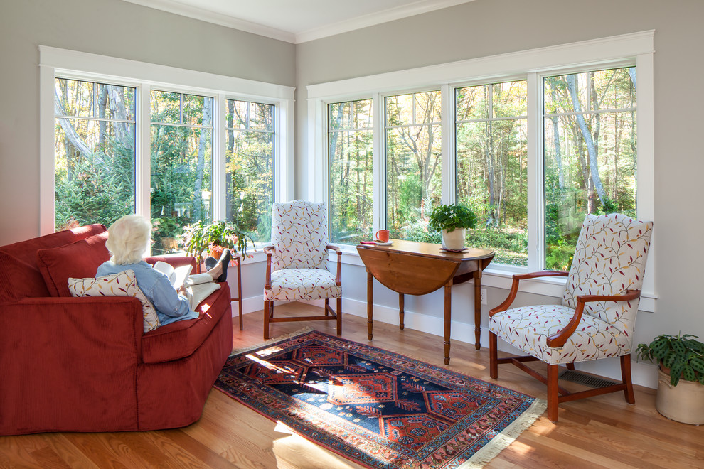 Photo of a medium sized traditional conservatory in Portland Maine with medium hardwood flooring, a standard ceiling and multi-coloured floors.
