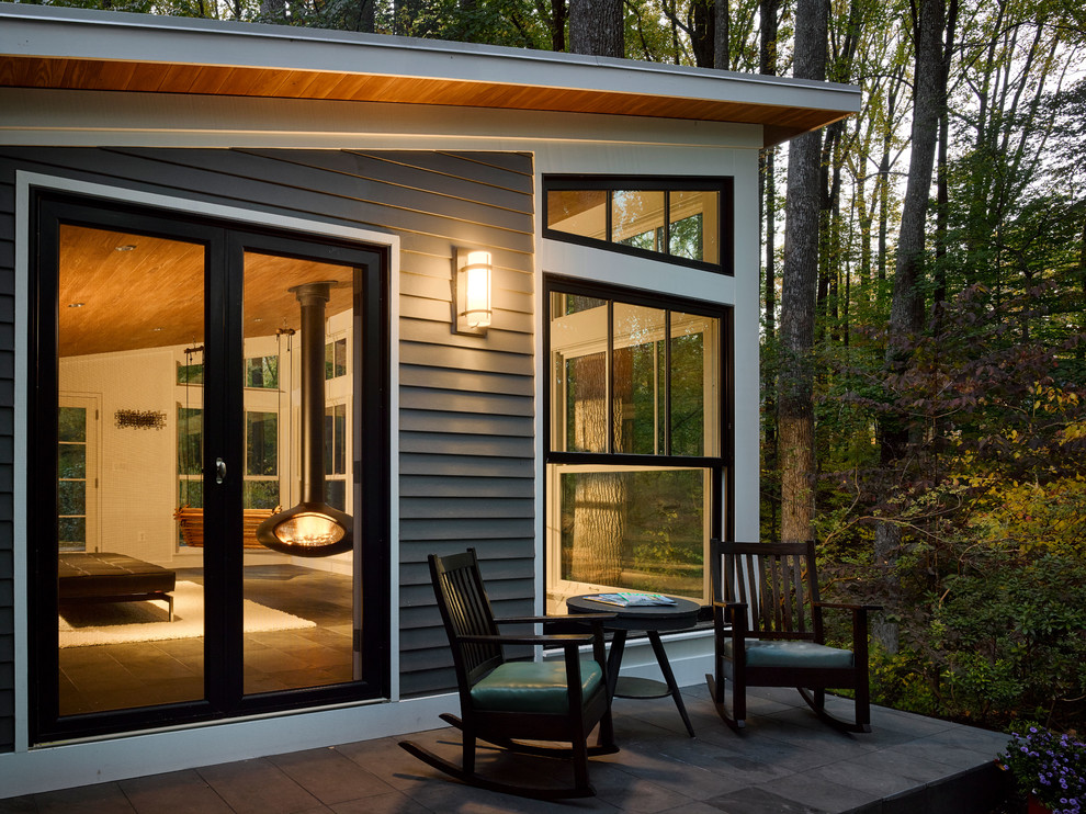 Medium sized modern conservatory in Baltimore with slate flooring, a hanging fireplace and a standard ceiling.