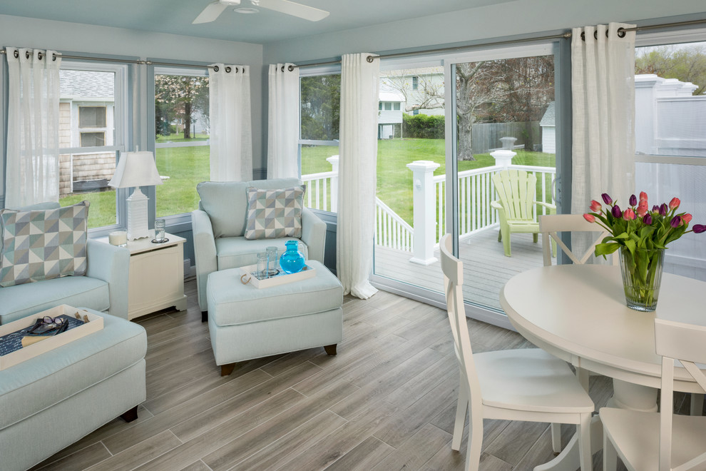 Small beach style conservatory in Providence with porcelain flooring, a standard ceiling and grey floors.