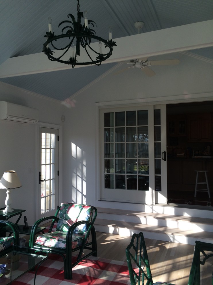 Example of a large classic light wood floor and beige floor sunroom design in New York with no fireplace and a standard ceiling