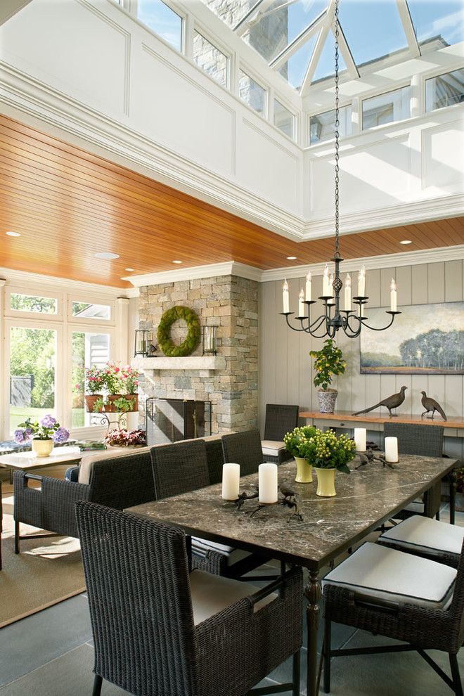 Inspiration for a farmhouse conservatory in Boston with a stone fireplace surround and a glass ceiling.