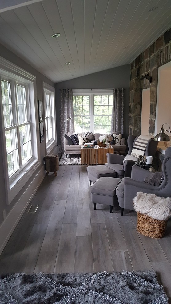Mid-sized transitional medium tone wood floor and gray floor sunroom photo in Toronto with no fireplace and a standard ceiling