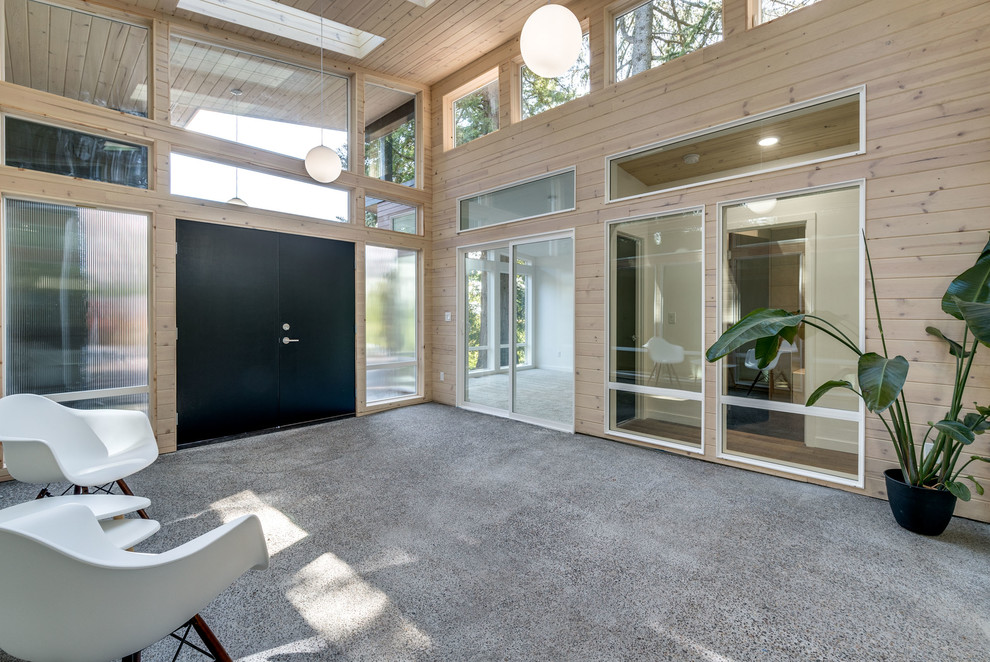 Photo of an expansive modern conservatory in Portland with concrete flooring and a standard ceiling.