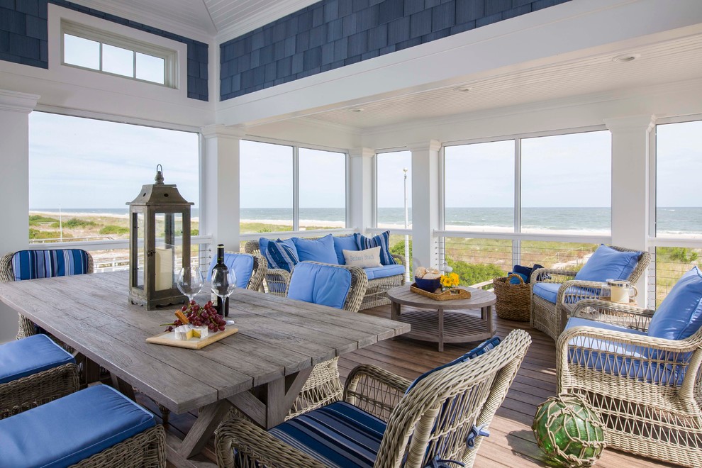 Example of a beach style medium tone wood floor and brown floor sunroom design in Miami with a standard ceiling