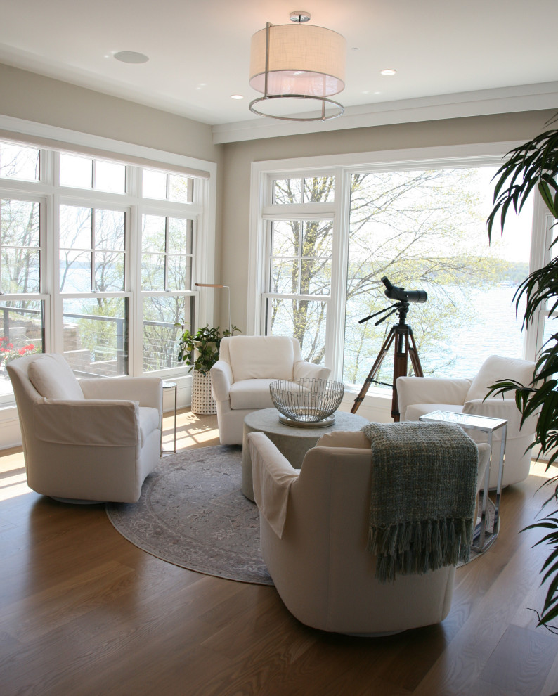 Medium sized traditional conservatory in Milwaukee with light hardwood flooring and brown floors.
