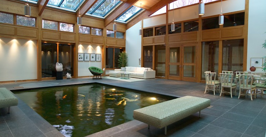Photo of a large contemporary conservatory in New York with a skylight, ceramic flooring and no fireplace.