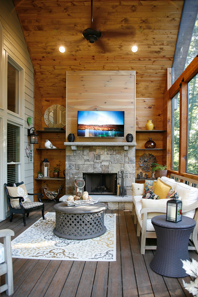 Medium sized rustic conservatory in Atlanta with a standard fireplace, a stone fireplace surround, medium hardwood flooring, a standard ceiling and brown floors.