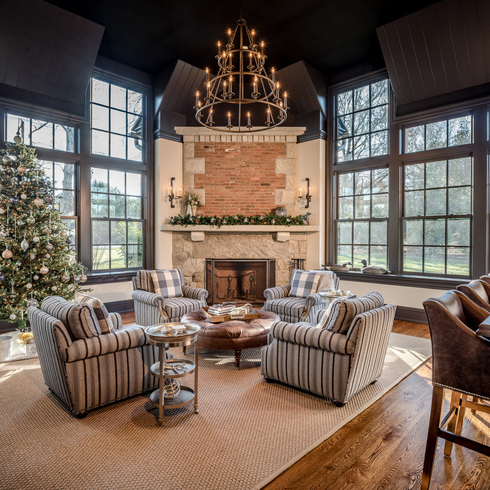 Large traditional conservatory in Philadelphia with medium hardwood flooring, a corner fireplace, a stone fireplace surround, a standard ceiling and brown floors.